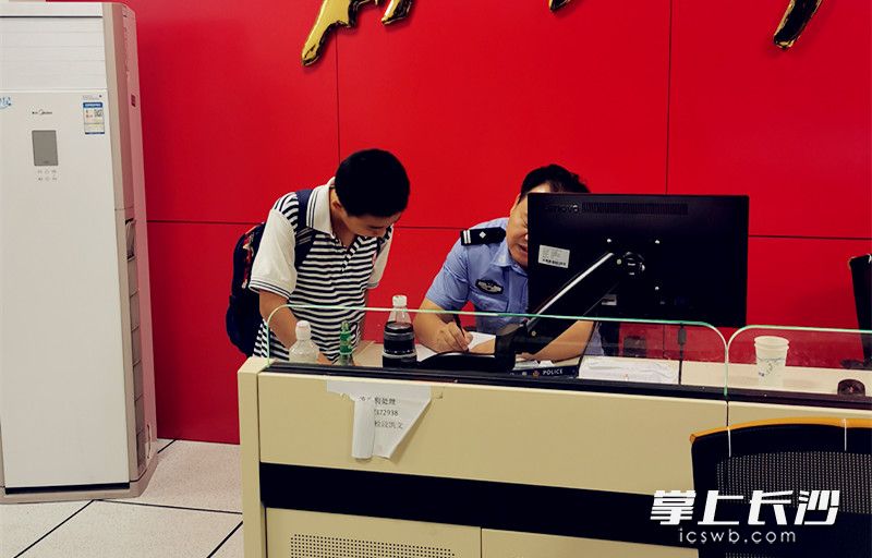 王琪霖和媽媽將撿到裝有貴重物品的提包找到派出所交給了值班警察,。東風(fēng)小學(xué)供圖