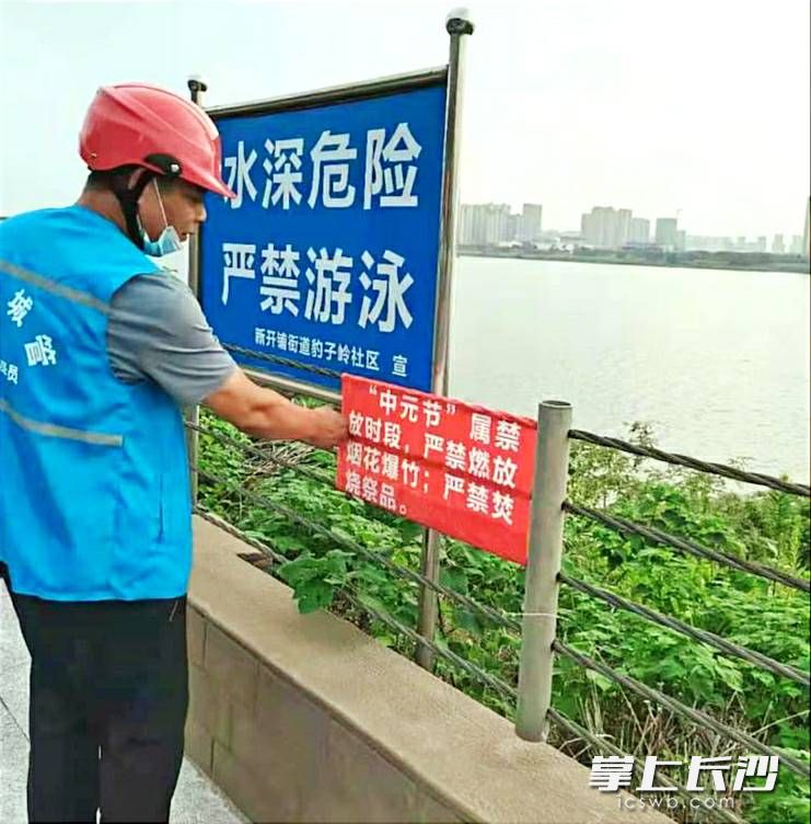 新開鋪街道工作人員在湘江風(fēng)光帶張貼文明祭祀宣傳標(biāo)語。長沙晚報(bào)通訊員 張覺新   供圖