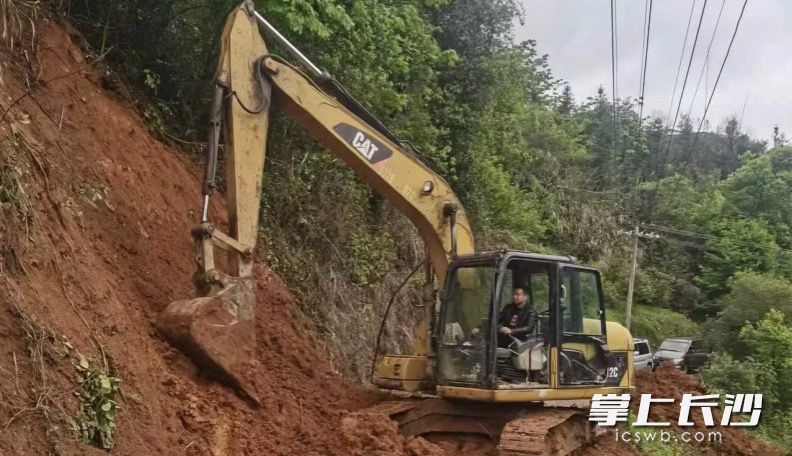 張志申清理滑坡泥土。