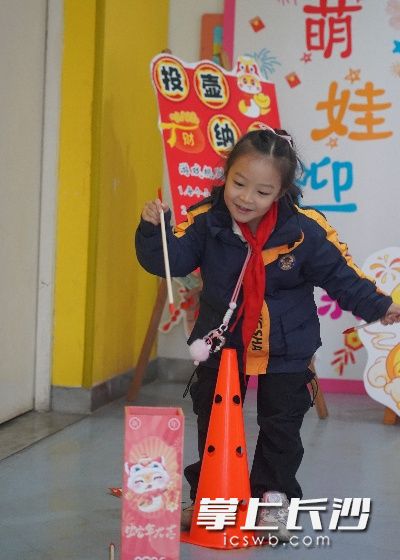 一名小女孩在玩投壺游戲,。均為長沙晚報通訊員肖悅供圖