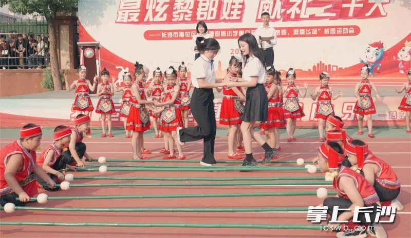 砂子塘黎郡小學(xué)師生共跳竹竿舞。